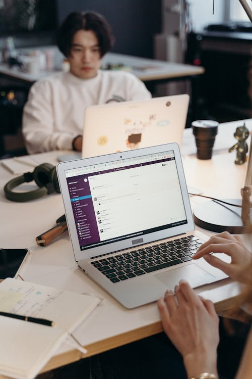 two people sitting at their desks